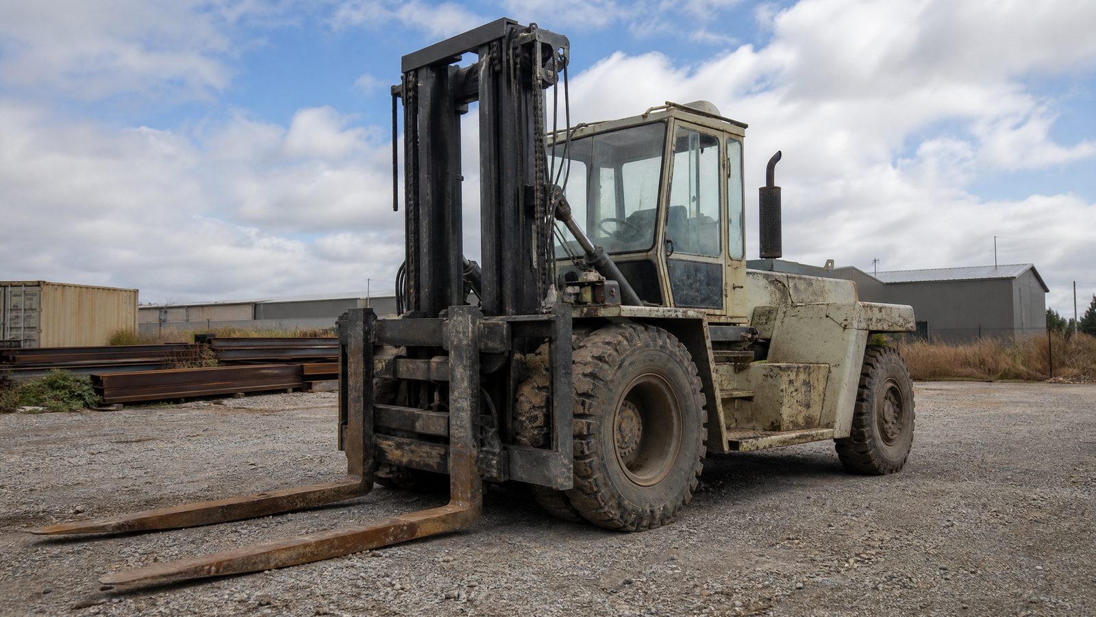 High capacity enclosed cab forklift purchased from an outdoor steel yard
